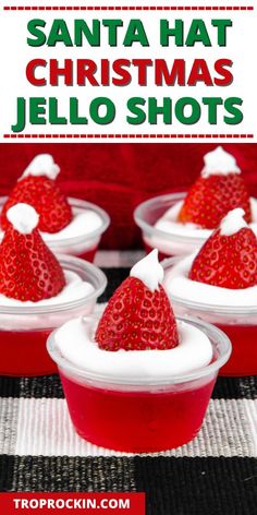 four small plastic cups with strawberries in them and the words santa hat christmas jello shots