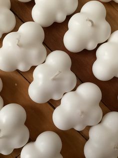 white candles are arranged on a wooden table