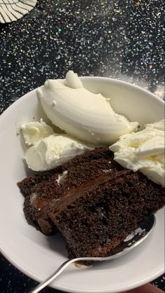 a white plate topped with chocolate cake and ice cream