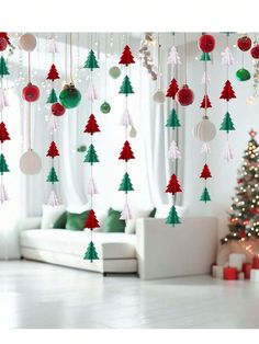 a living room with christmas decorations hanging from the ceiling and a christmas tree on the wall