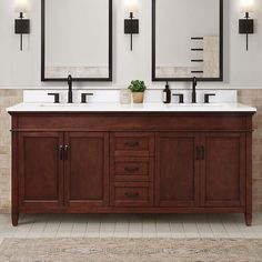 a bathroom vanity with two mirrors above it