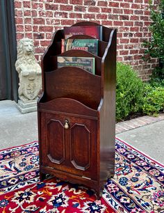 a wooden book holder sitting on top of a rug in front of a brick wall