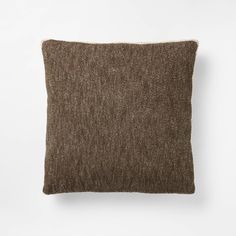 a brown pillow sitting on top of a white wall