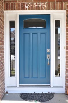 a blue front door on a brick house