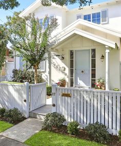 a house with white picket fence in front of it