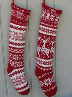 two red and white christmas stockings hanging from hooks