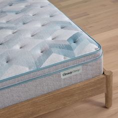 an image of a mattress on a wooden bed frame