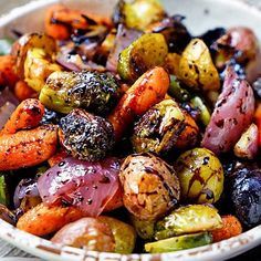 a white bowl filled with different types of vegetables