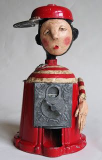 a ceramic figurine wearing a red hat and holding a knife