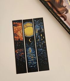 three bookmarks with the same painting on them