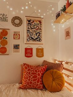 a bed with pillows and pictures on the wall