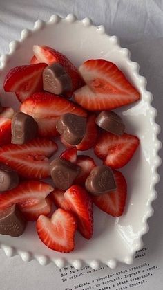 a white bowl filled with chocolate covered strawberries