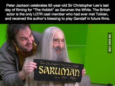 two people holding up a sign with the caption saying,'peter jackson celebrates 82 - year - old christopher lee is last day of filming for the hobbi