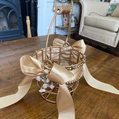 a basket that has some flowers in it on a table next to a chair and fireplace