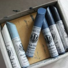 four blue crayons are in a box