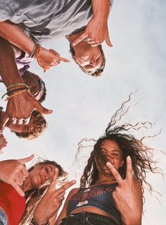 four people standing in a circle with their fingers up