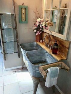 a bathroom with two sinks and towels hanging on the wall