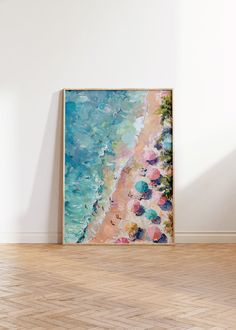 a painting hanging on the wall in an empty room with wood flooring and white walls