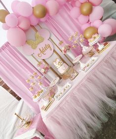 a pink and gold baby shower party with lots of balloons, cake and cupcakes