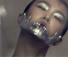 a woman with silver foil on her face