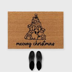 a door mat with the words merry christmas written on it and black shoes next to it