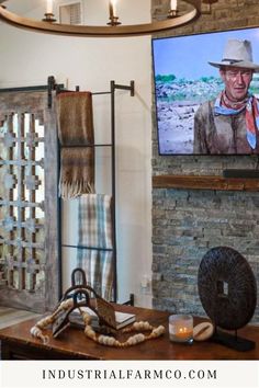 a living room filled with furniture and a flat screen tv mounted on the wall next to a fireplace