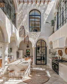 an indoor kitchen with white walls and arches