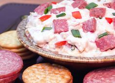 a plate full of food with crackers on the side