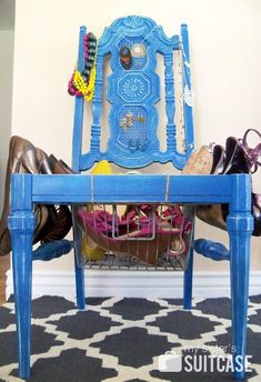 a blue chair with shoes underneath it and a basket under the seat in front of it