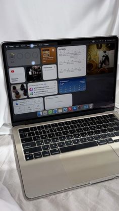 an open laptop computer sitting on top of a bed