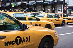 taxis are lined up on the street in new york city