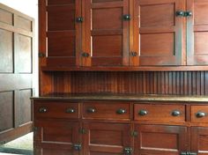 a wooden cabinet with metal handles and knobs