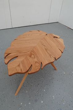 a wooden table that has been made to look like a leaf