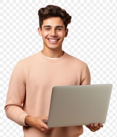 a young man holding a laptop computer in his right hand and smiling at the camera