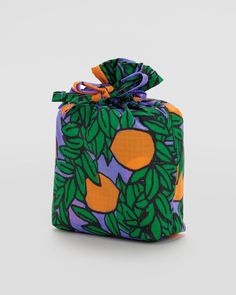 an orange and green bag with leaves on it