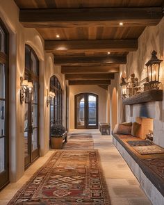 a large hallway with lots of windows and rugs