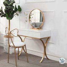 a white desk with a mirror and chair in front of it, next to a potted plant