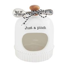 a salt and pepper shaker that says just a pinch on the front with a wooden spoon sticking out of it