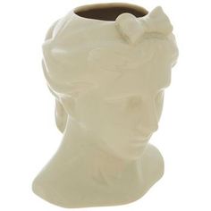 a white ceramic head vase with a bow on it's side, against a white background