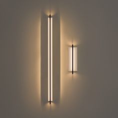 two lights are on the wall next to each other