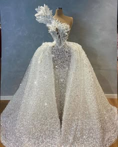 a dress made out of white sequins and feathers