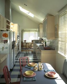 the kitchen is clean and ready to be used for dinner or lunchtime, with dishes on the table