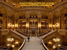 an ornate building with many stairs and chandeliers in it's center area