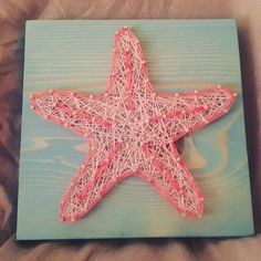 a string art starfish on a wooden board