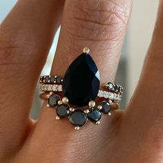 A curvier version of the Black Diamond Headdress Jacket, this stackable ring always pairs beautifully with 3 stone rings, especially spready oval solitaire engagement rings and rounds. Available in 18k gold and platinum. Contact us for pricing. Diamond Engagement Ring With Black Accents, Black Diamond Gold Engagement Ring, Vintage Black Diamond Ring, Unique Black Engagement Rings, Black Oval Wedding Ring, Black Wedding Ring For Women, Unique Engagement Rings Non Traditional Vintage, Dark Wedding Rings, Black Stone Engagement Ring