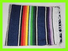 a multicolored striped rug with fringes