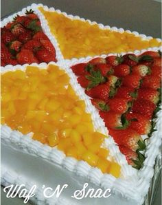 a cake decorated with fruit and white frosting