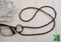 Layers wonderfully with your other jewelry and keeps your glasses handy to prevent that annoying glasses hunt and the loss of your expensive sunglasses! Crafted by me, this beautiful eyeglass loop necklace is elegant and as well as practical.  When you are wearing your glasses, it is also a great long necklace just by itself!  The necklace is 4mm genuine leopardskin jasper stone beads and the copper color metal ring to hold your glasses has an opening of 1", which accommodates most eyeglass stems.   Choose the length of your necklace - available in 24, 28 or 32 inches, which slips easily over your head.   ֍ Looking for a different color or different length necklace?  I love to do custom orders!  Send me a message letting me know what you are looking for.   **Glasses not included** Purchase Expensive Sunglasses, Leopardskin Jasper, Loop Necklace, Eyeglasses Holder, Eyeglass Necklace, Glasses Chains, Glasses Holder, Eyeglass Holder, Glasses Chain