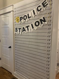 the police station sign is taped to the wall