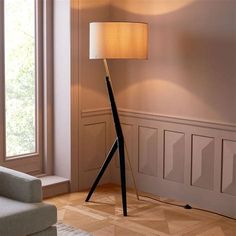 a floor lamp in the corner of a living room